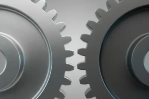 Two mismatched gears nearly touching on a soft gray background, symbolizing a failed HR automation process.