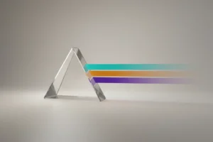 Glass prism splits a single light beam into multiple color bands on a neutral background, symbolizing tailored employer branding.
